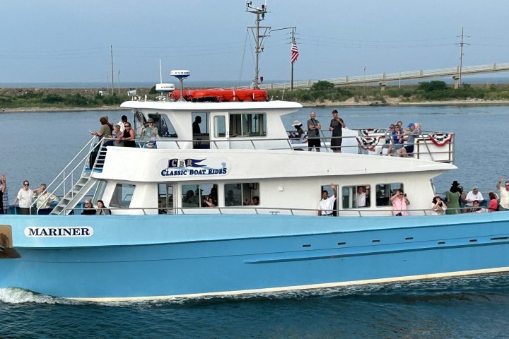 a group of people in a small boat in a large body of water